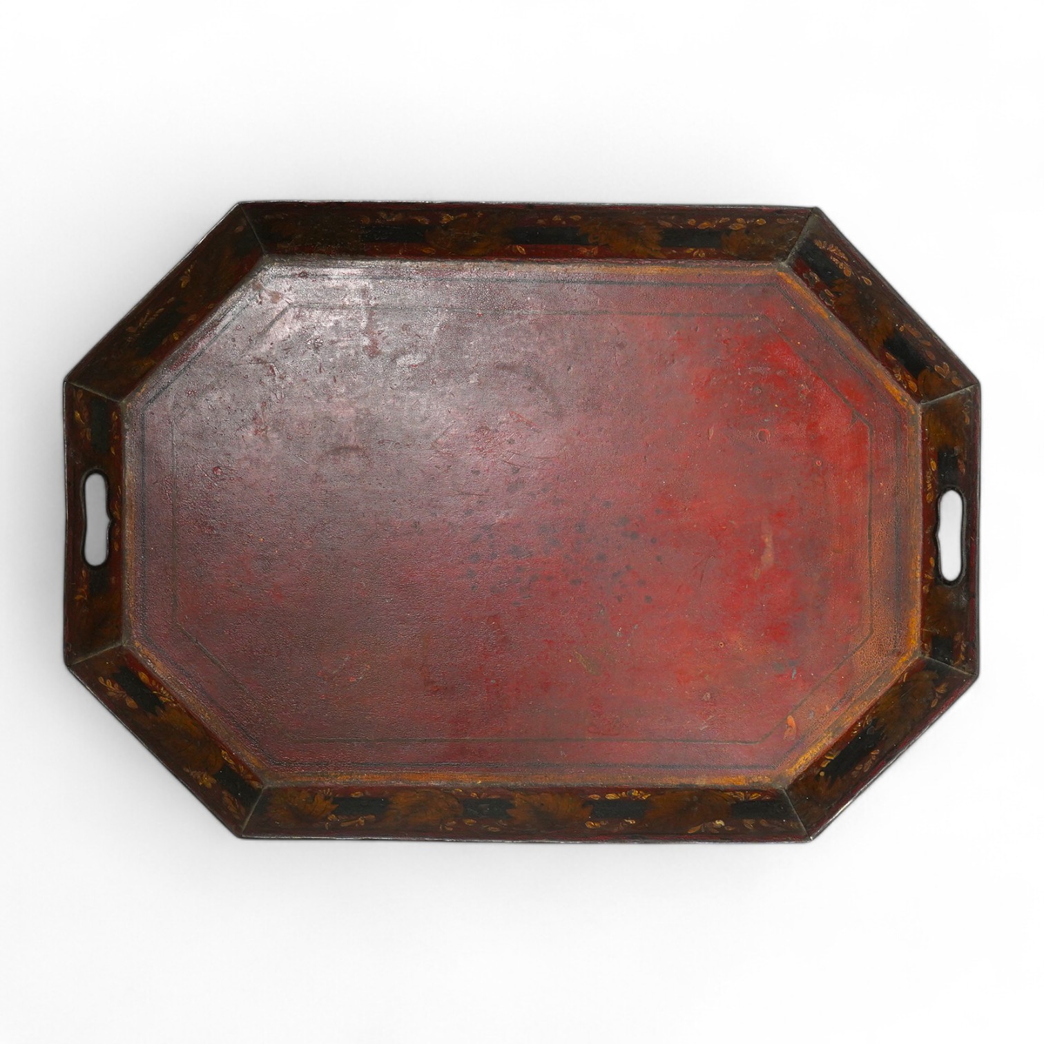 An early 19th century octagonal red painted toleware tray, possibly Pontypool, 66cm wide. Condition - poor